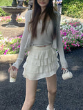 Knitting Season_Soft Sky Silk Sling With Two Sets Of White Knitted Cardigan Outside Sunscreen